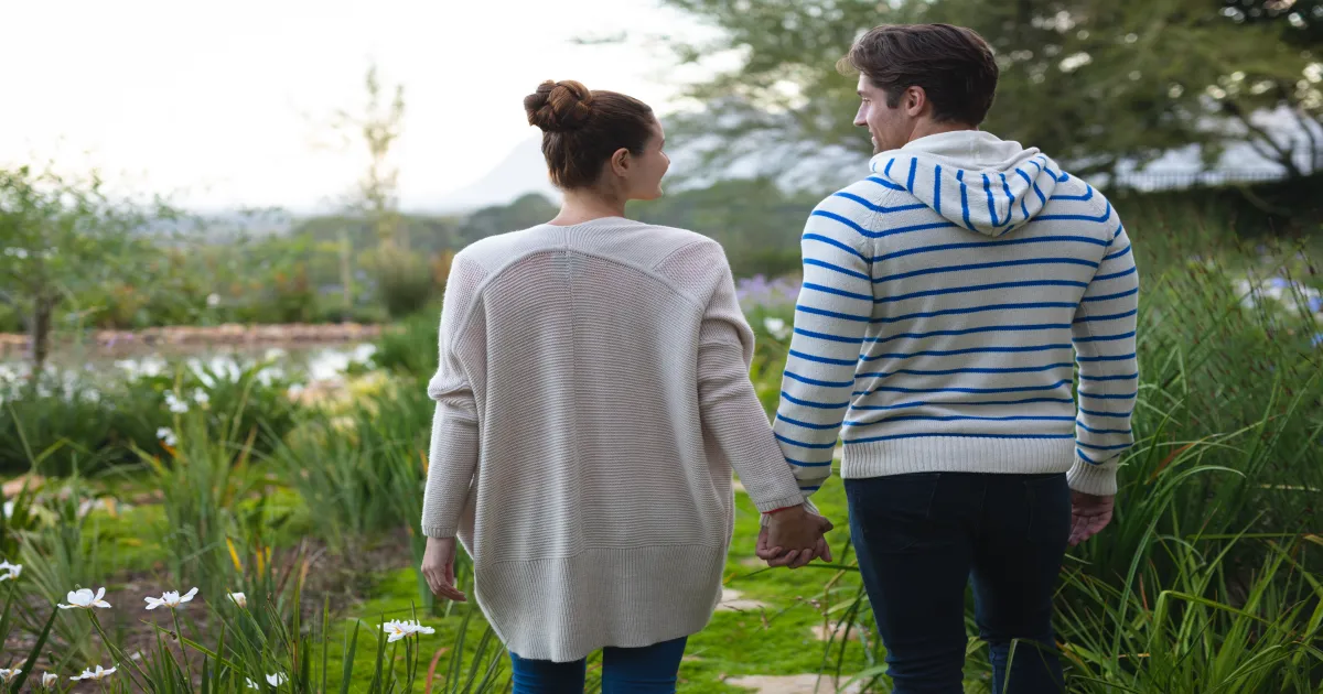 Couple holding hands on a romantic garden stroll date